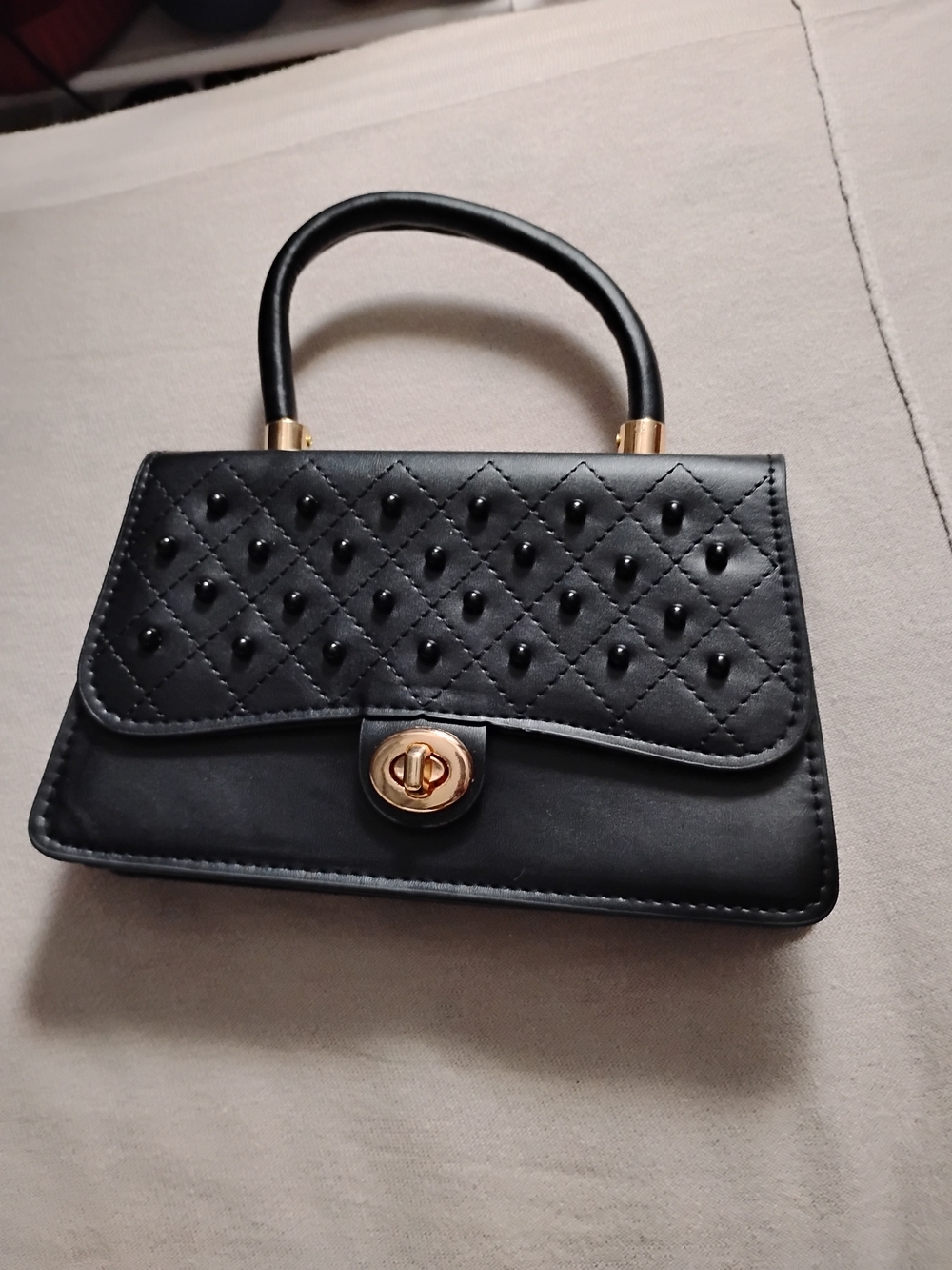 Black Quilted Top-Handle Bag with Gold Hardware
